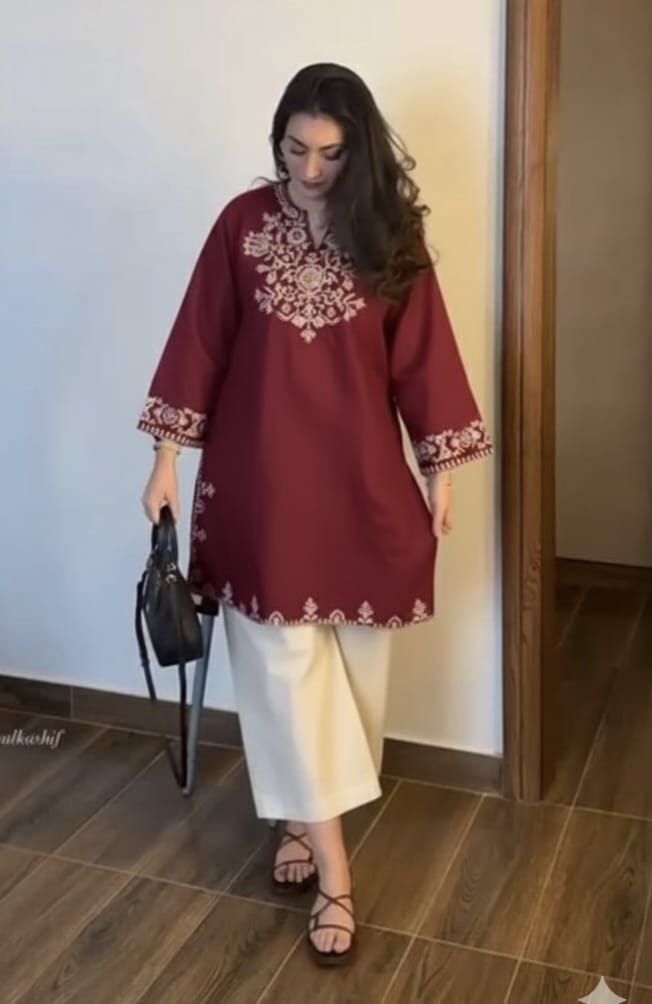 The lightweight kurta features intricate thread embroidery along the neckline, sleeves,