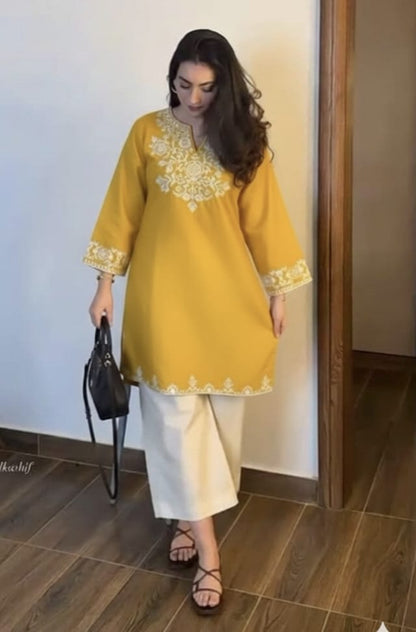 The lightweight kurta features intricate thread embroidery along the neckline, sleeves,